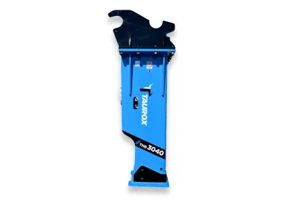Hydraulic breaker breaking through rock or concrete on site